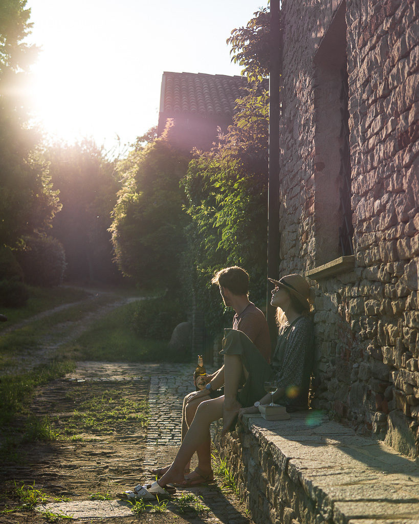 Luke & Nell enjoying a glass of beer one evening on their garden wall in Piedmont, Italy.