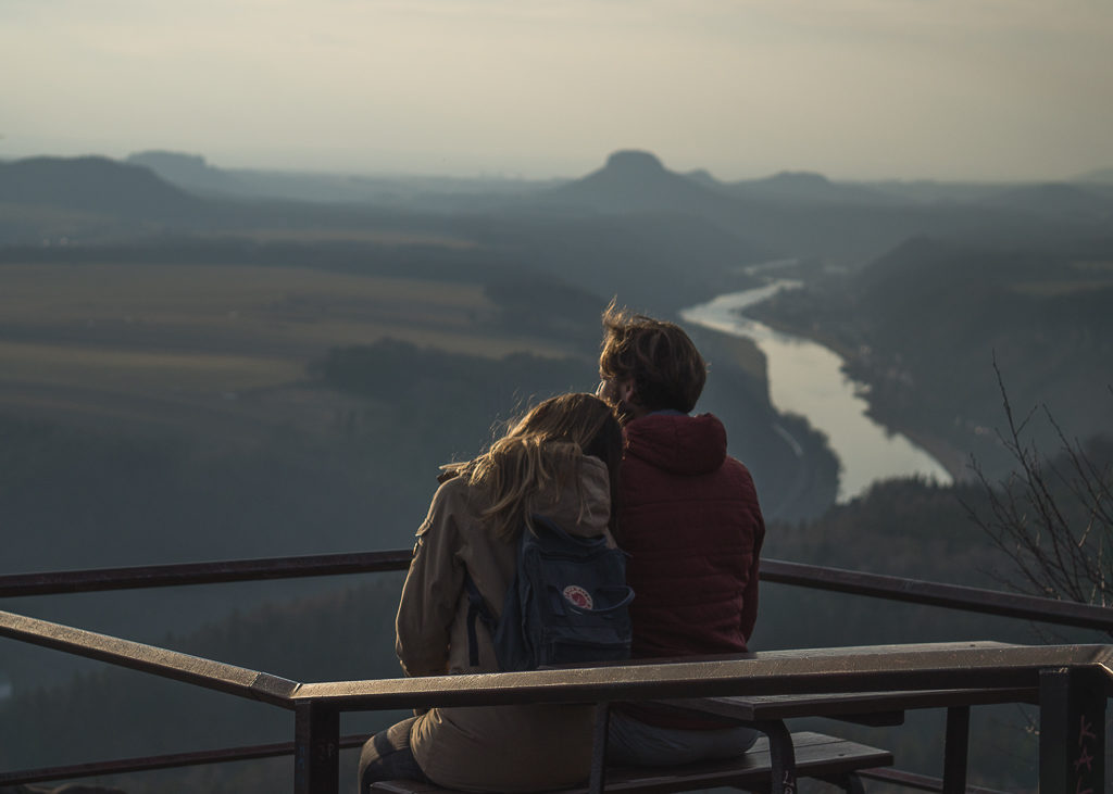 Luke & Nell sitting looking out over the River Elbe in Saxon Switzerland, Germany high up on the Painters' Way trail near to Schmilka.