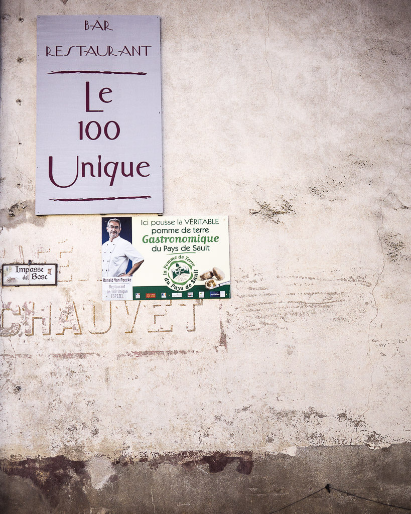 Le 100 Unique run by brilliant chef Ronald from Belgium - seen here by the advertisement with his photograph on the side of a typical crumbling French wall