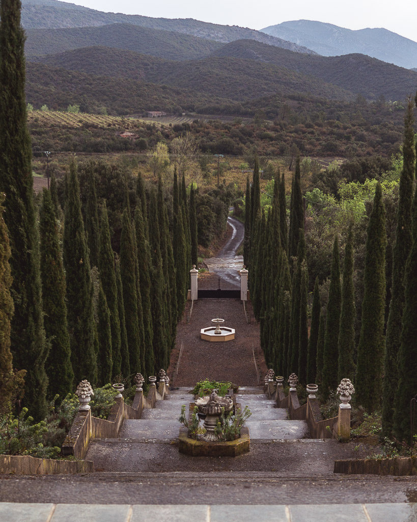 Looking out on the countryside from Domaine Coussères just off the Cathar Way. View down the grand cypress tree lined steps leading up to the hotel.
