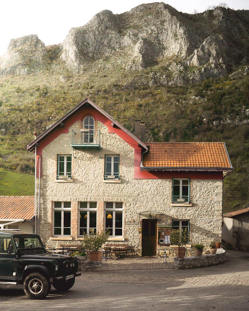 View of the Roquefixade gîte with rocky outcrop towering behind