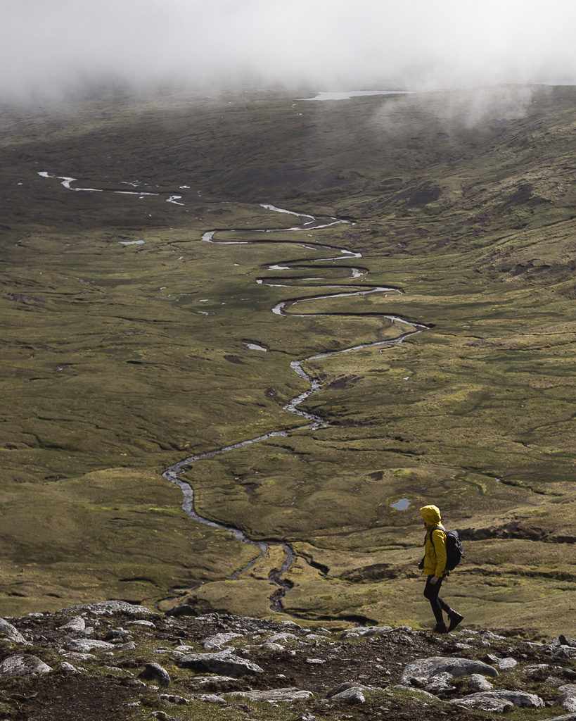 Nell walking near Saksun high above a dramatically meandering river.