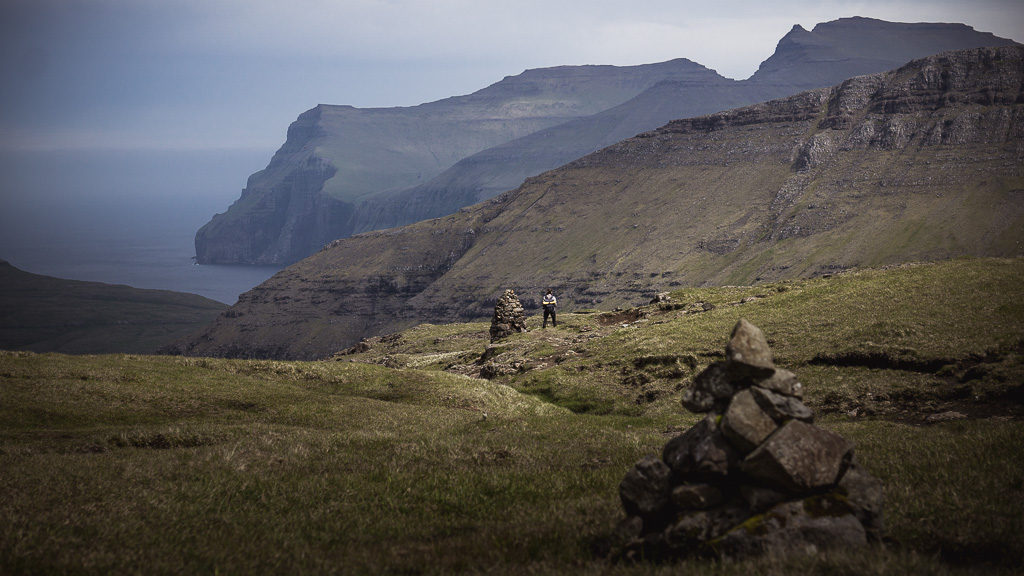 Nell hiking on the Faroe Islands from cairn to cairn.