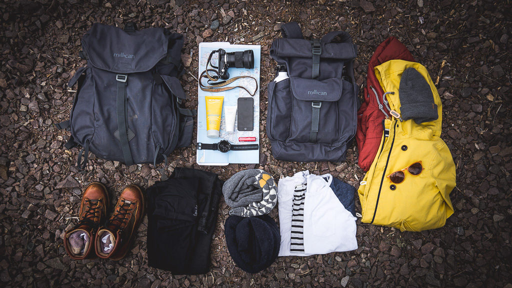 Flat lay showing what to pack for hiking in the Faroe Islands. Items described in blog post.