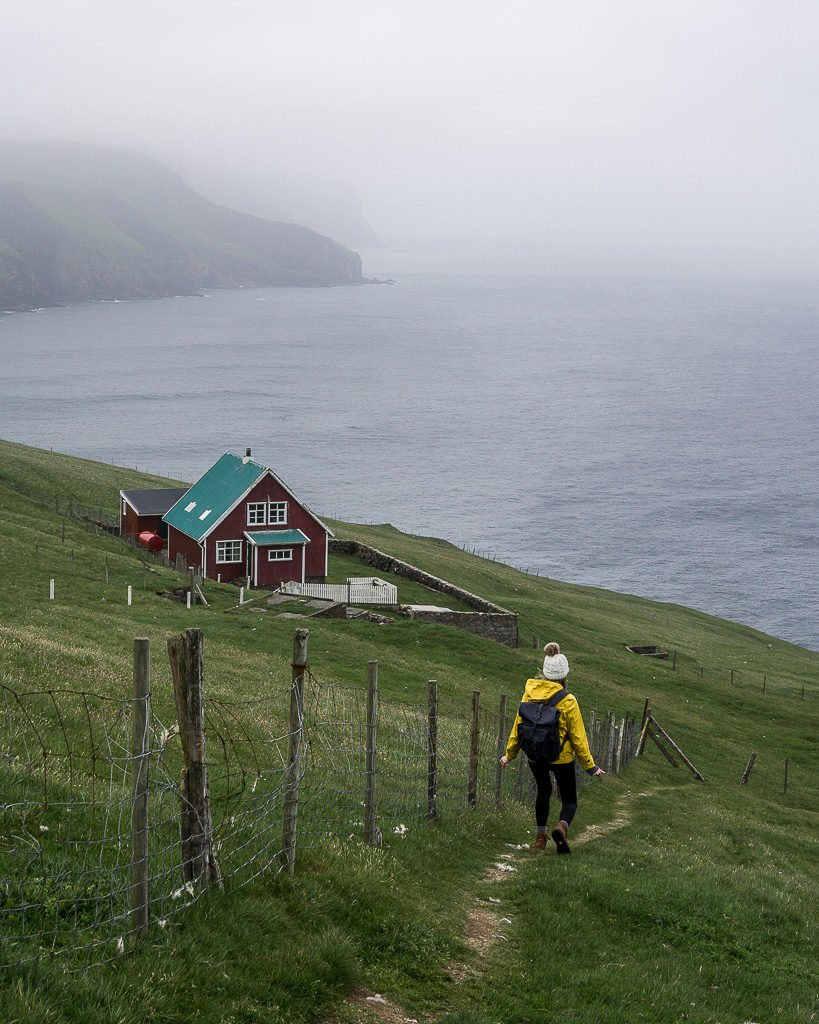 Visiting the Mykines puffins takes you to one of the best lighthouses we've seen. Here's Nell walking down towards the lighthouse keeper's cottage.
