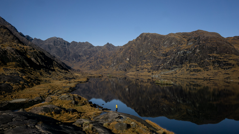 Nell standing on the shores of the loch making the Loch Coruisk boat and hike trip the best thing to do on Skye